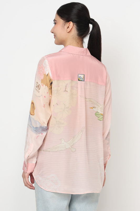 Woman wearing a pastel-colored shirt with graphic designs on a white background