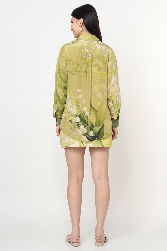 Woman wearing a green floral co-ord set on a white background