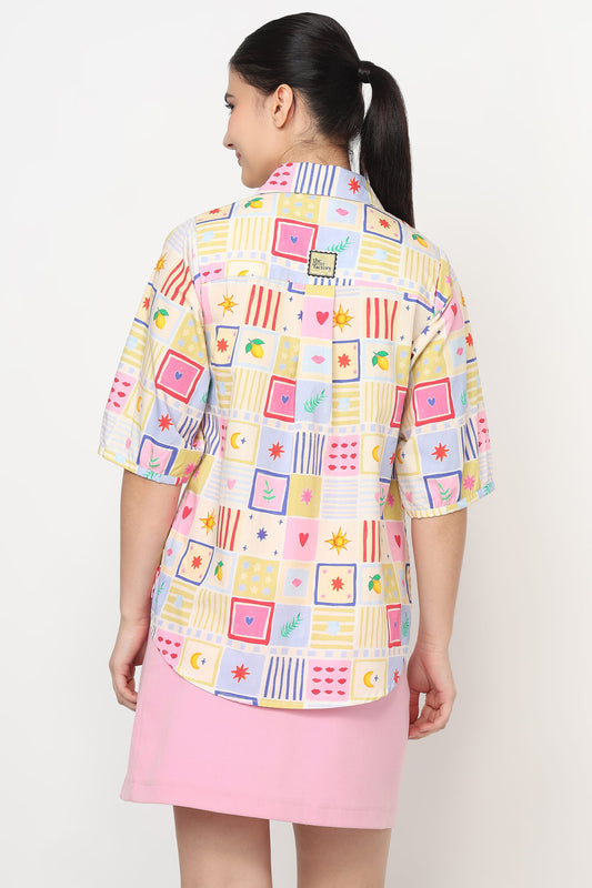 Woman wearing a colorful checkered shirt and pink skirt on a white background