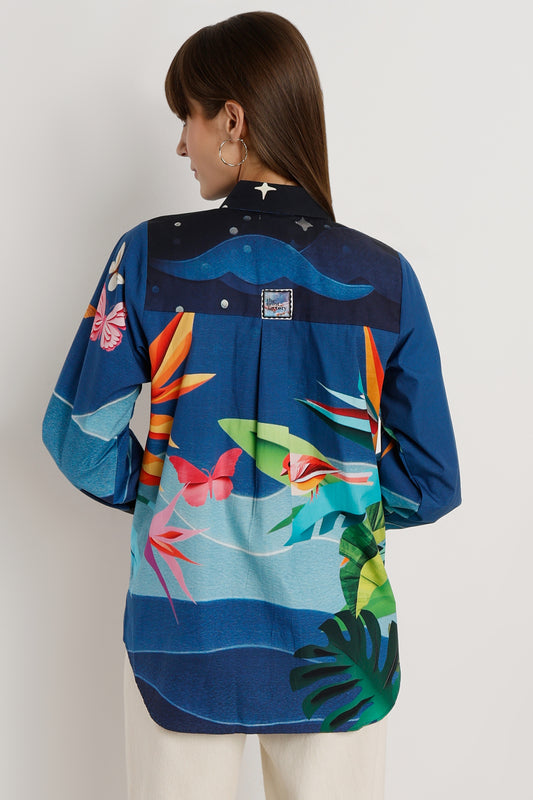 Woman wearing a colorful floral shirt with a white background