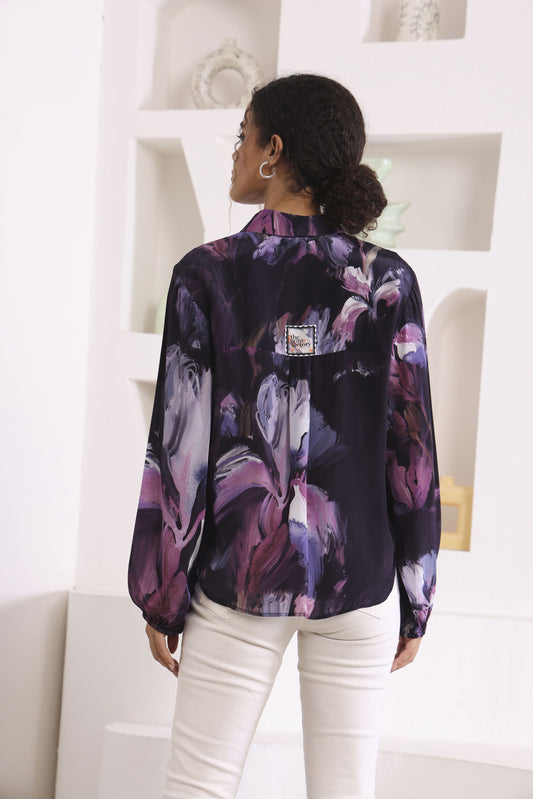 Person wearing a floral blouse with a white background