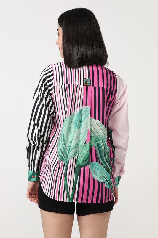 Person wearing a colorful shirt with a striped pattern and leaf design on a white background