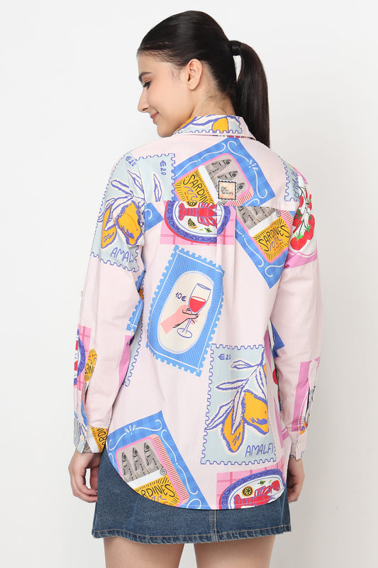 Person wearing a colorful patterned shirt with a white background