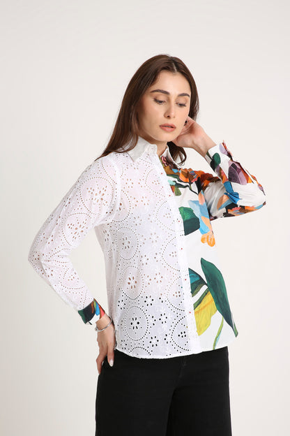 Woman wearing a white Shirt blouse with floral patterns on a plain background