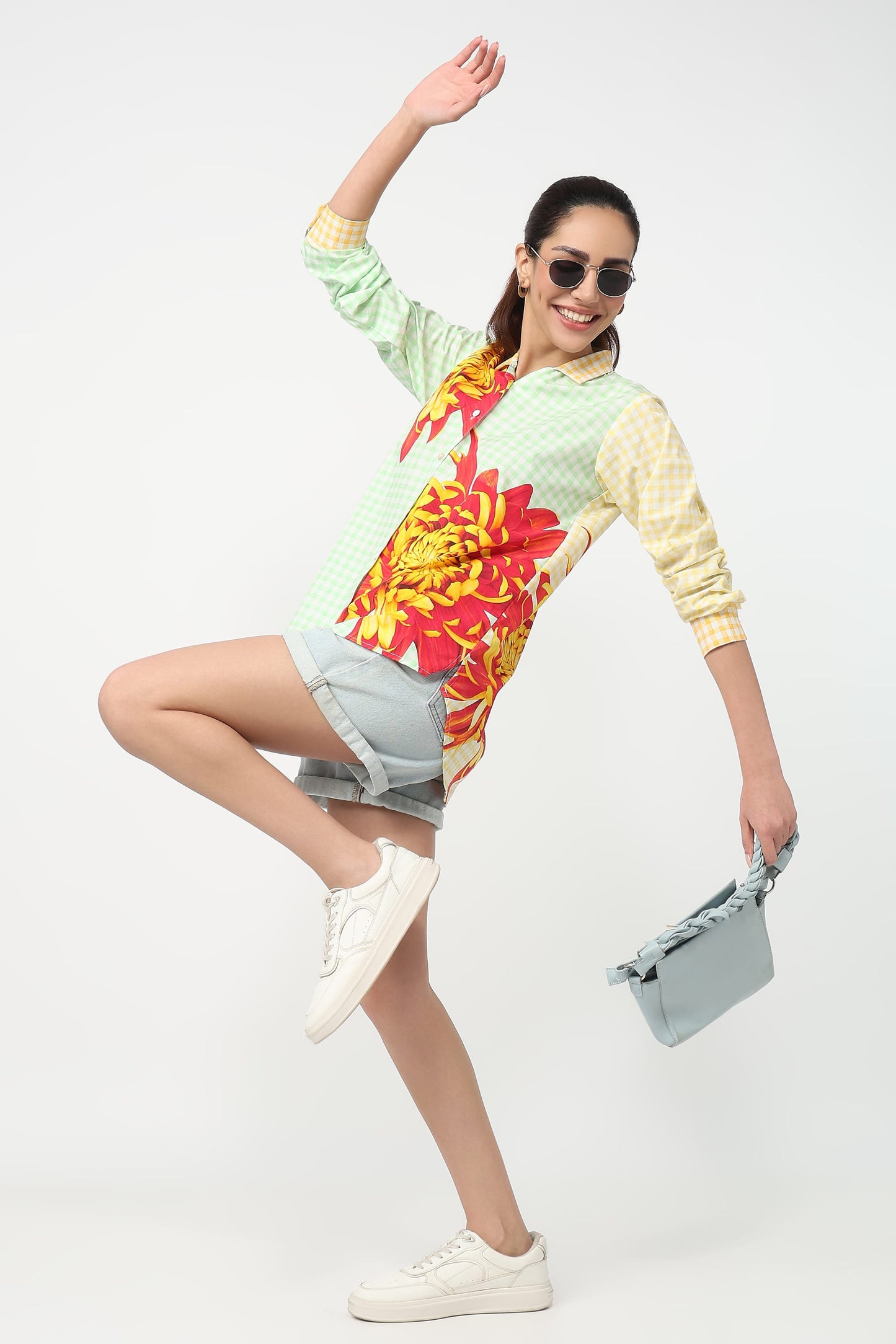 Woman wearing a colorful floral dress with a white background