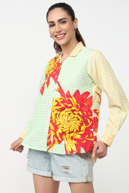 Woman wearing a colorful floral shirt with a white background