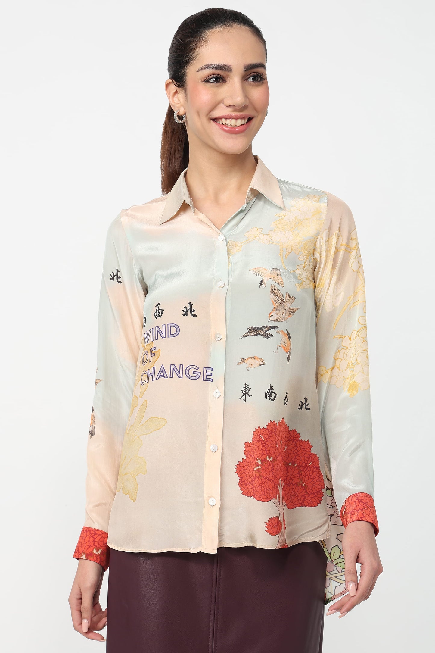 Woman wearing a floral and text-patterned shirt on a white background