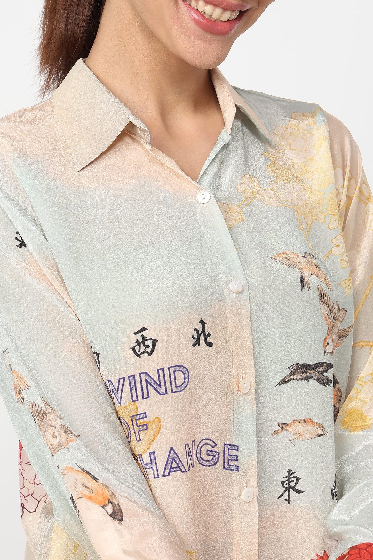 Crepe shirt with floral and text design worn by a person