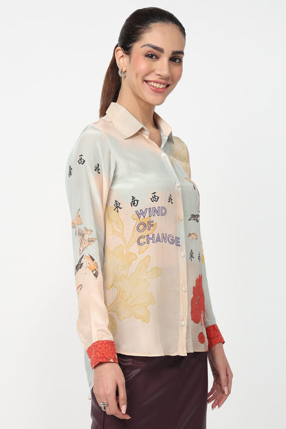 Woman wearing a colorful shirt with text and floral patterns on a white background