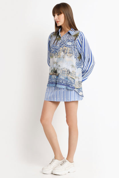 Woman wearing a blue and white patterned outfit on a white background