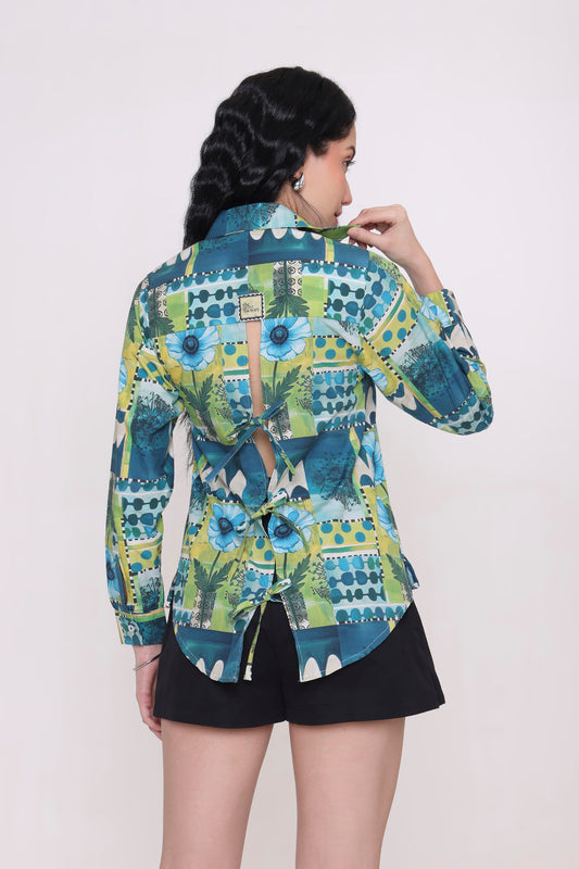 Woman wearing a colorful patterned shirt against a white background