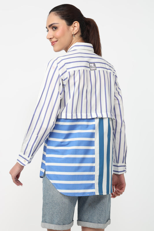 Woman wearing a blue and white striped shirt with a white background