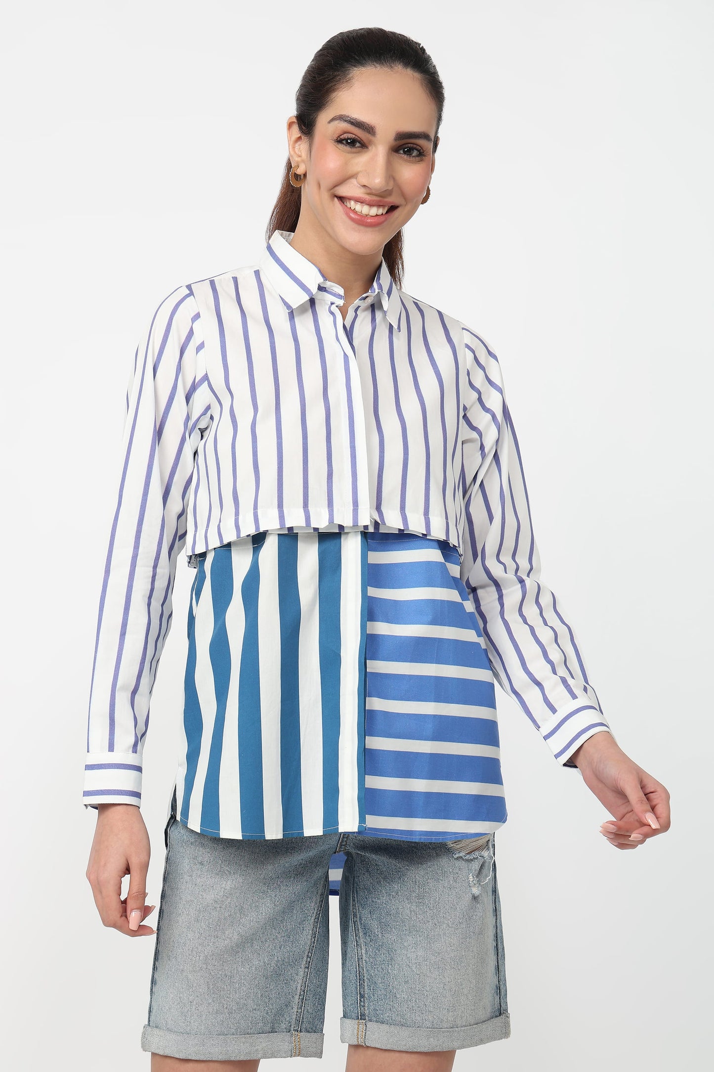 Woman wearing a blue and white striped shirt with a matching skirt on a white background