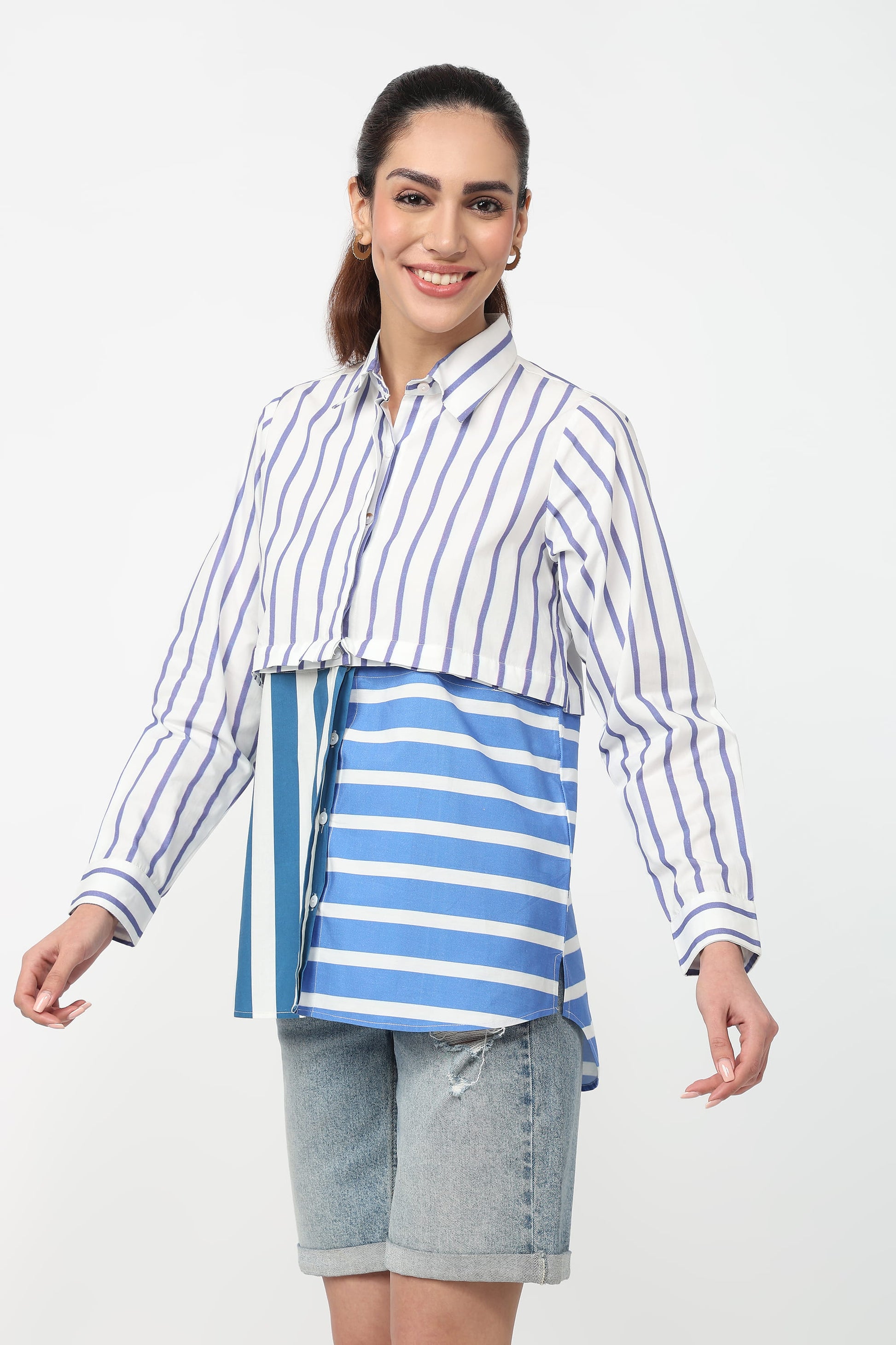 Woman wearing a blue and white striped shirt with a blue and white striped apron on a white background