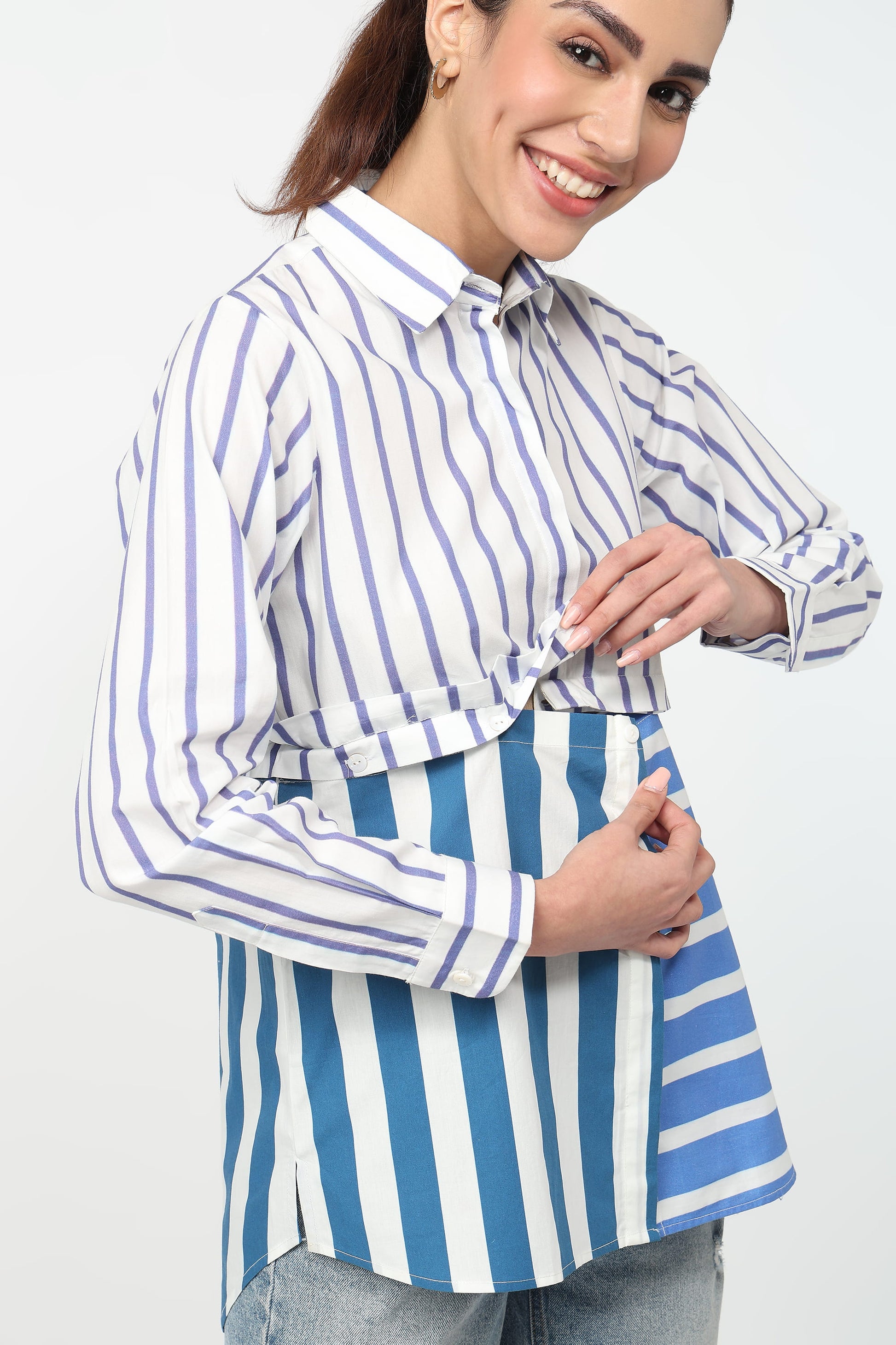 Woman wearing a blue and white striped shirt with a white background