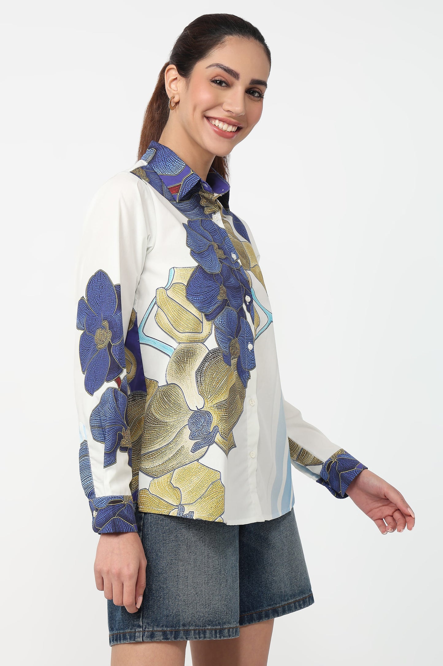 Woman wearing a floral patterned shirt with a white background