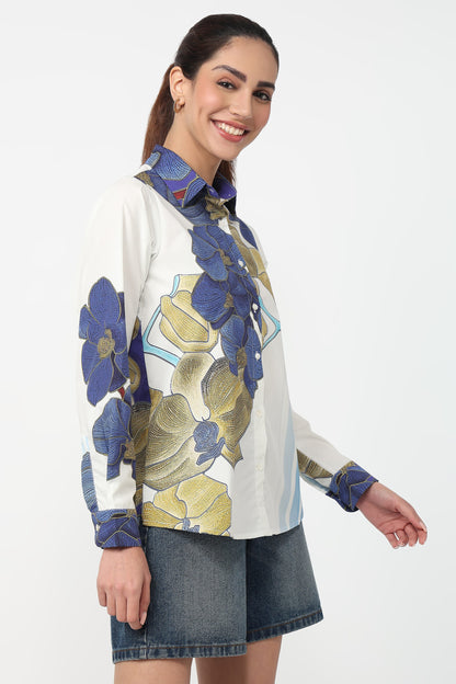 Woman wearing a floral patterned shirt with a white background
