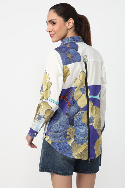 Woman wearing a colorful floral shirt with a white background