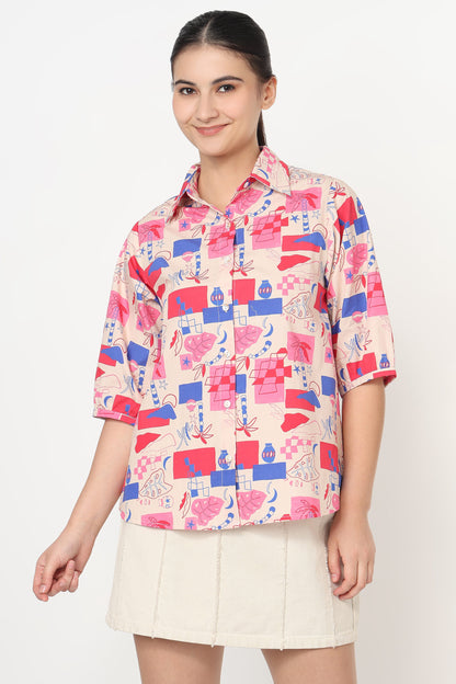 Woman wearing a colorful patterned shirt with a plain background