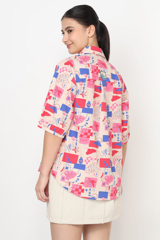 Woman wearing a colorful geometric patterned shirt on a white background