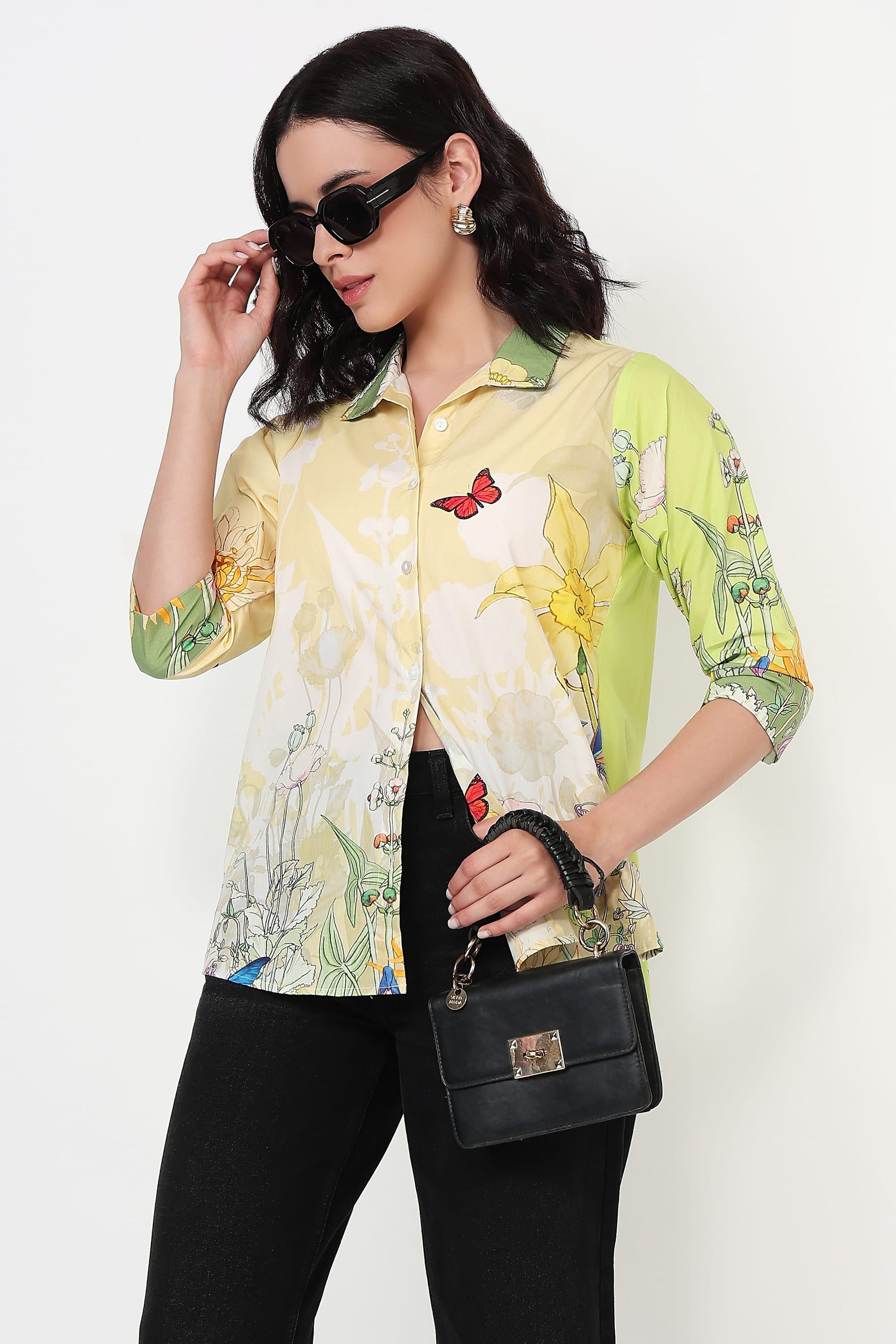 Woman wearing a colorful floral shirt with a white background
