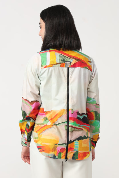 Person wearing a colorful jacket with abstract patterns on a white background