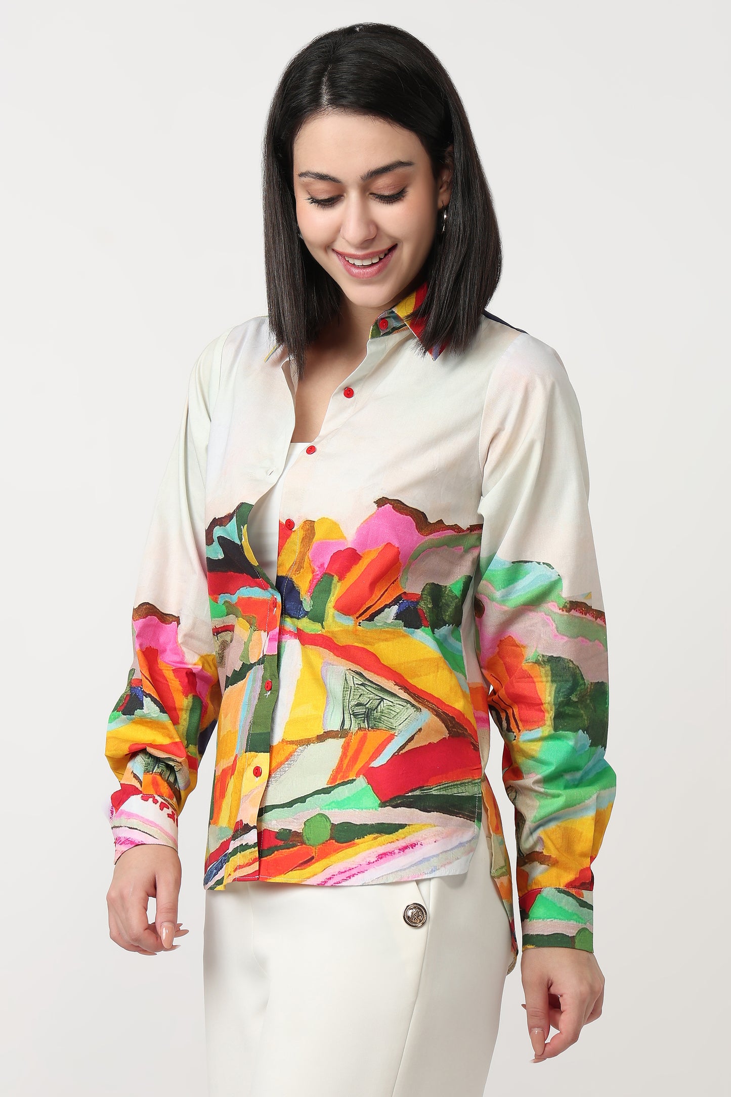 Woman wearing a colorful abstract patterned shirt on a white background