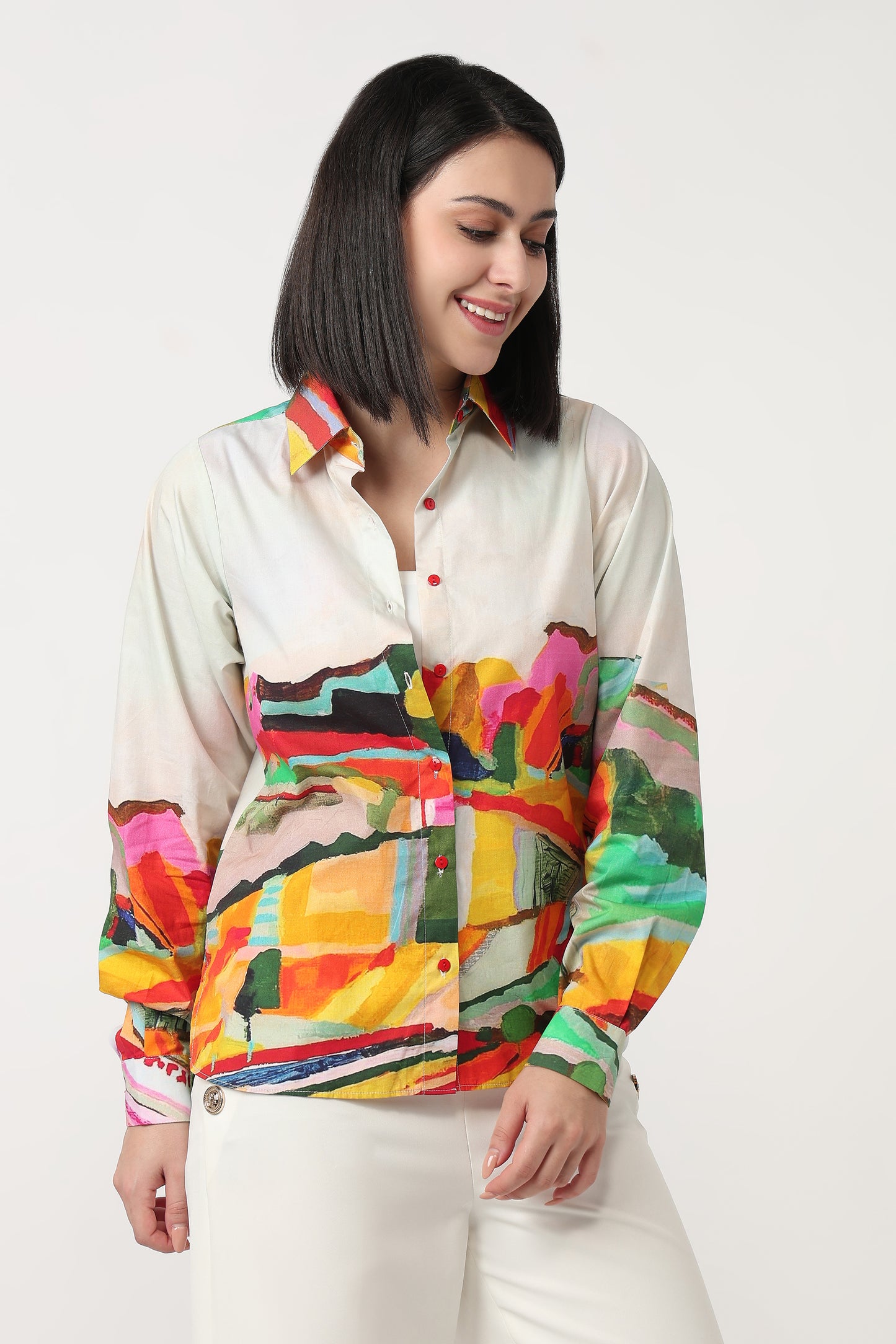 Woman wearing a colorful patterned shirt against a white background