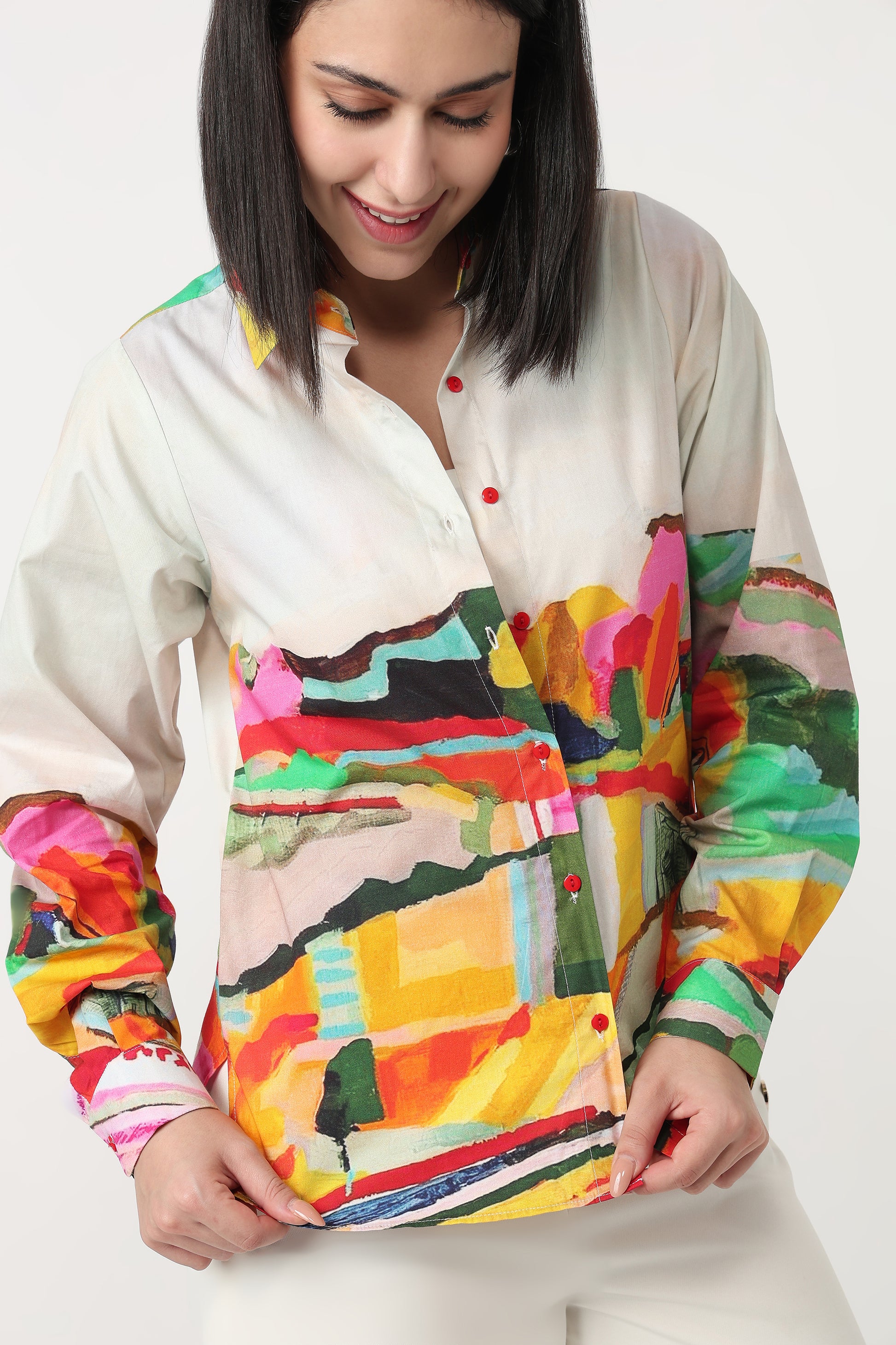 Woman wearing a colorful abstract patterned shirt on a white background