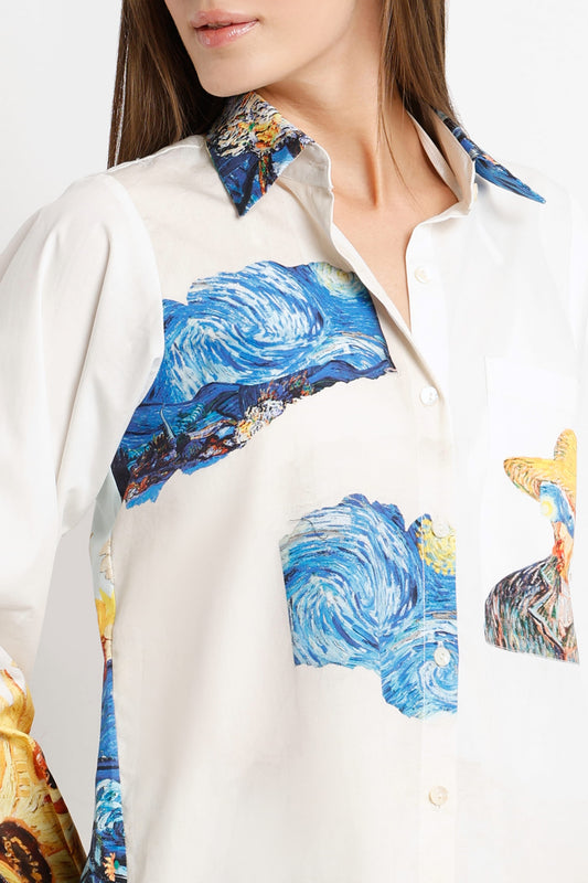 A close-up of a model wearing a white button-up shirt featuring Van Gogh-inspired art prints, including swirling blue and yellow waves and a horse motif.