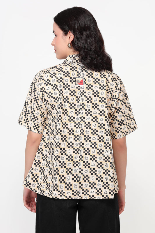 Woman wearing a patterned shirt on a white background