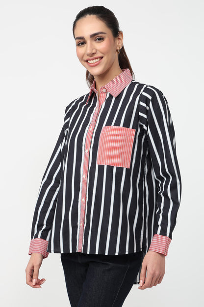 Woman wearing a black and white striped shirt with pink accents on a white background