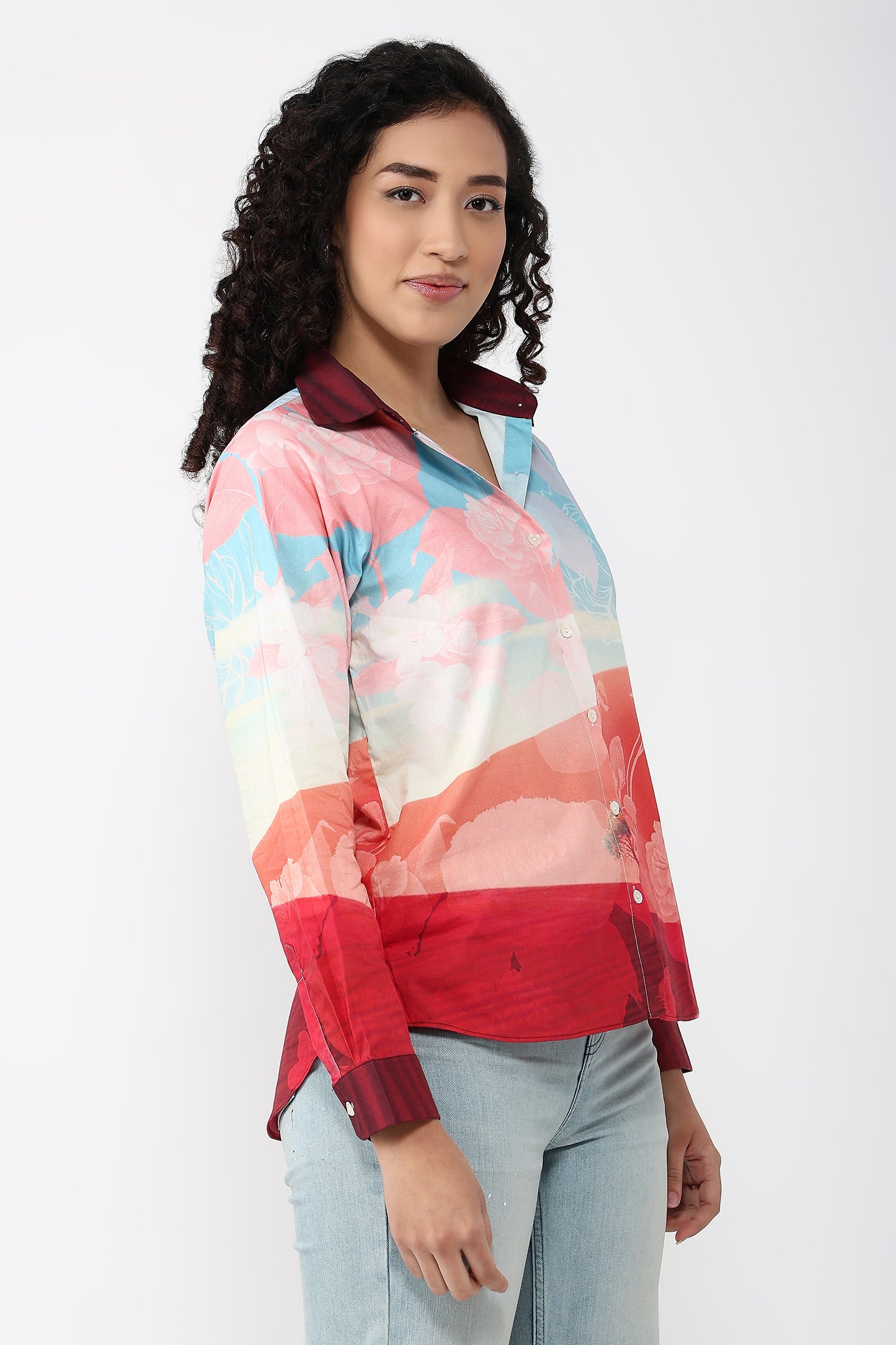 Woman wearing a colorful patterned shirt on a white background