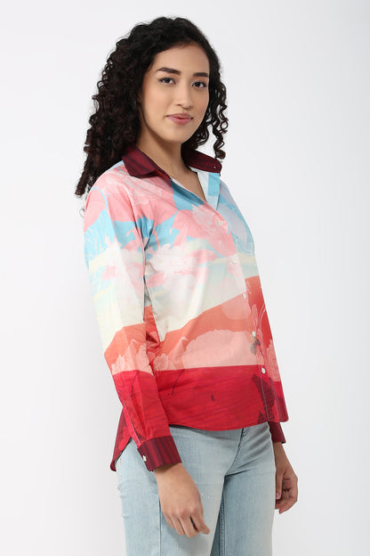 Woman wearing a colorful patterned shirt on a white background