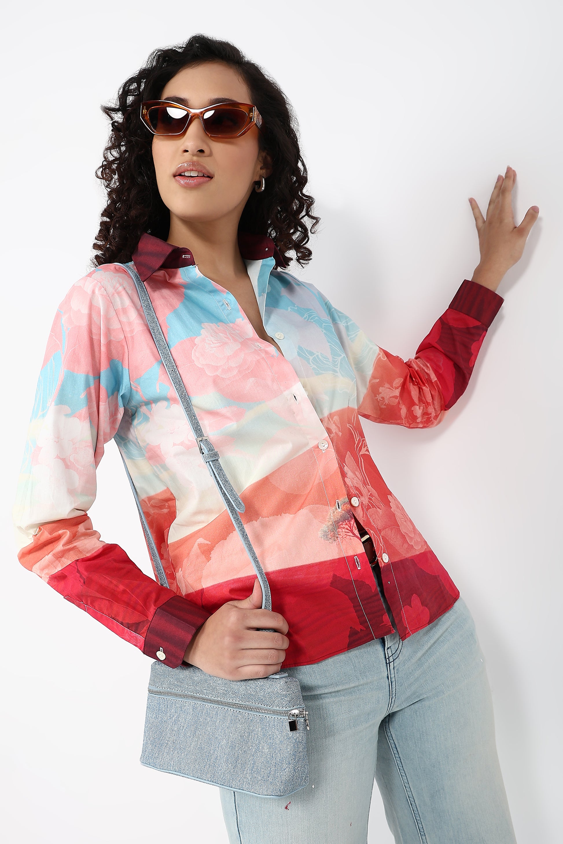 Woman wearing a colorful jacket with a white background