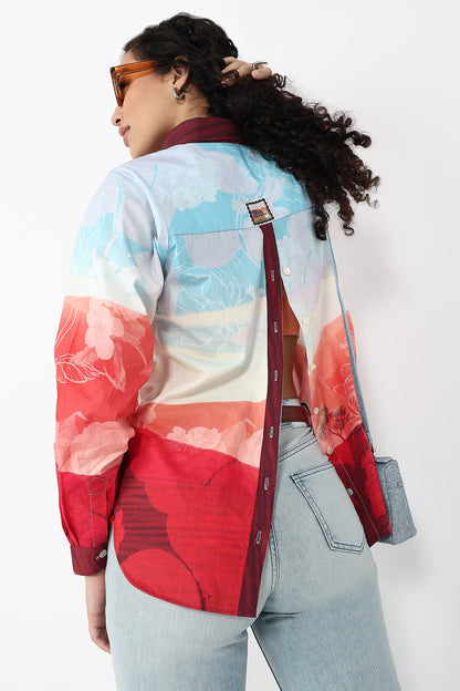Person wearing a colorful jacket with floral patterns on a white background