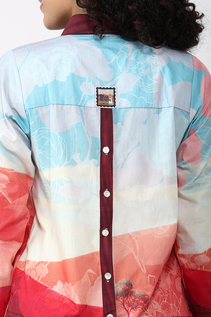 Colorful jacket with a patterned design and a red belt on a plain background