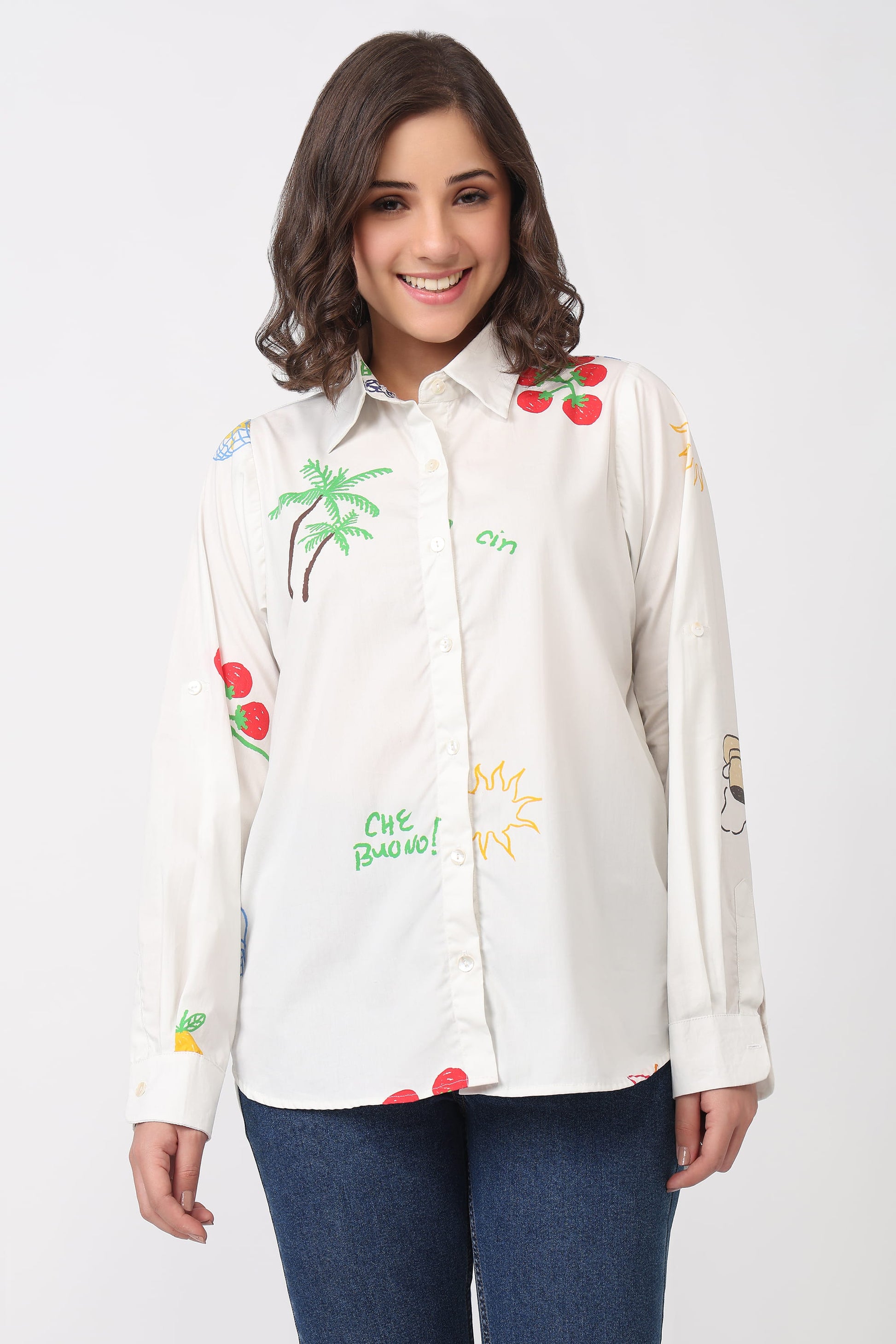Woman wearing a white shirt with colorful embroidery print on a white background