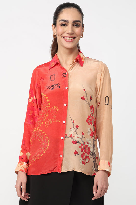 Woman wearing a red and beige shirt with floral designs on a white background