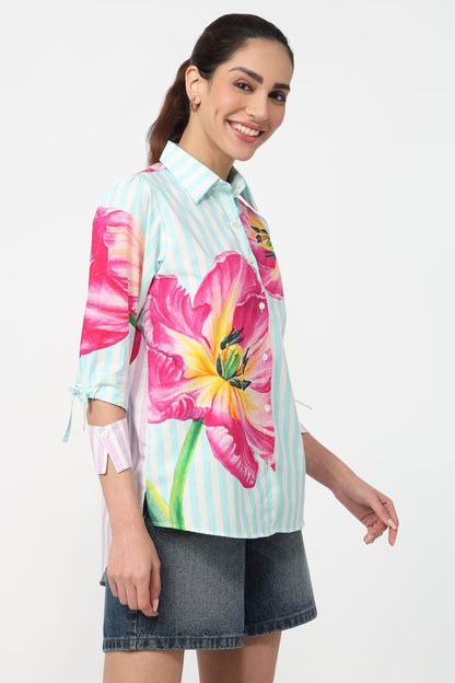 Woman wearing a colorful floral shirt with a white background