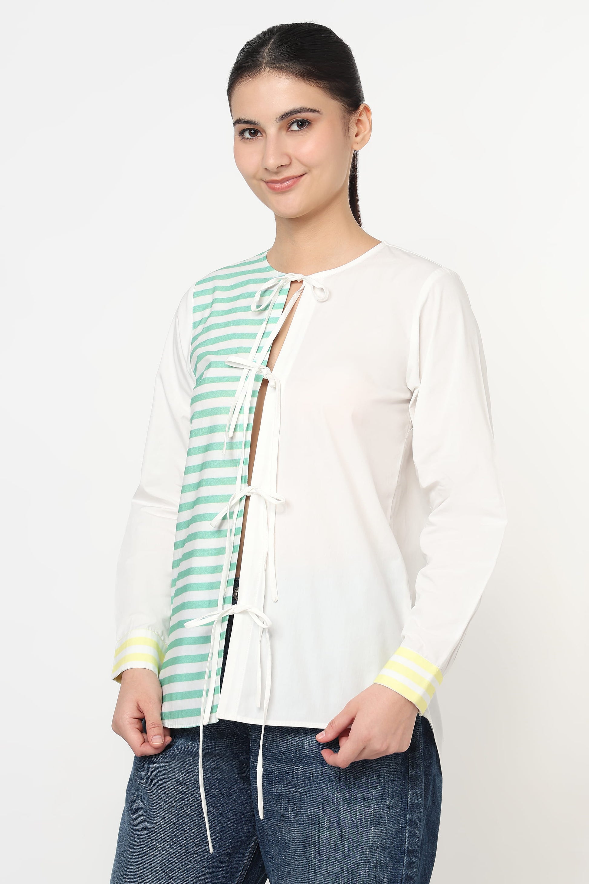 Woman wearing a white shirt with a green and white stripes on a white backgroung