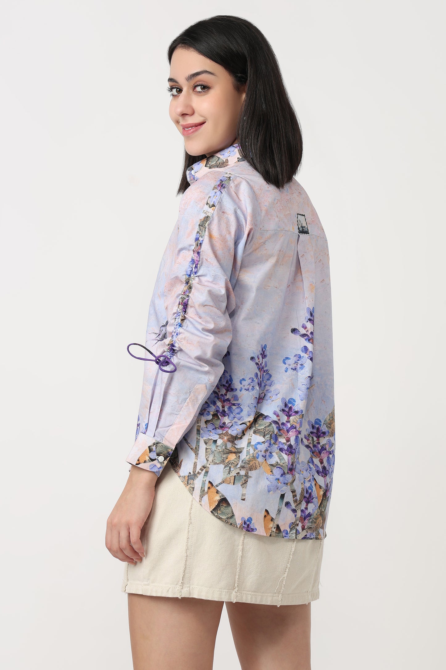 Woman wearing a floral blouse with a plain background