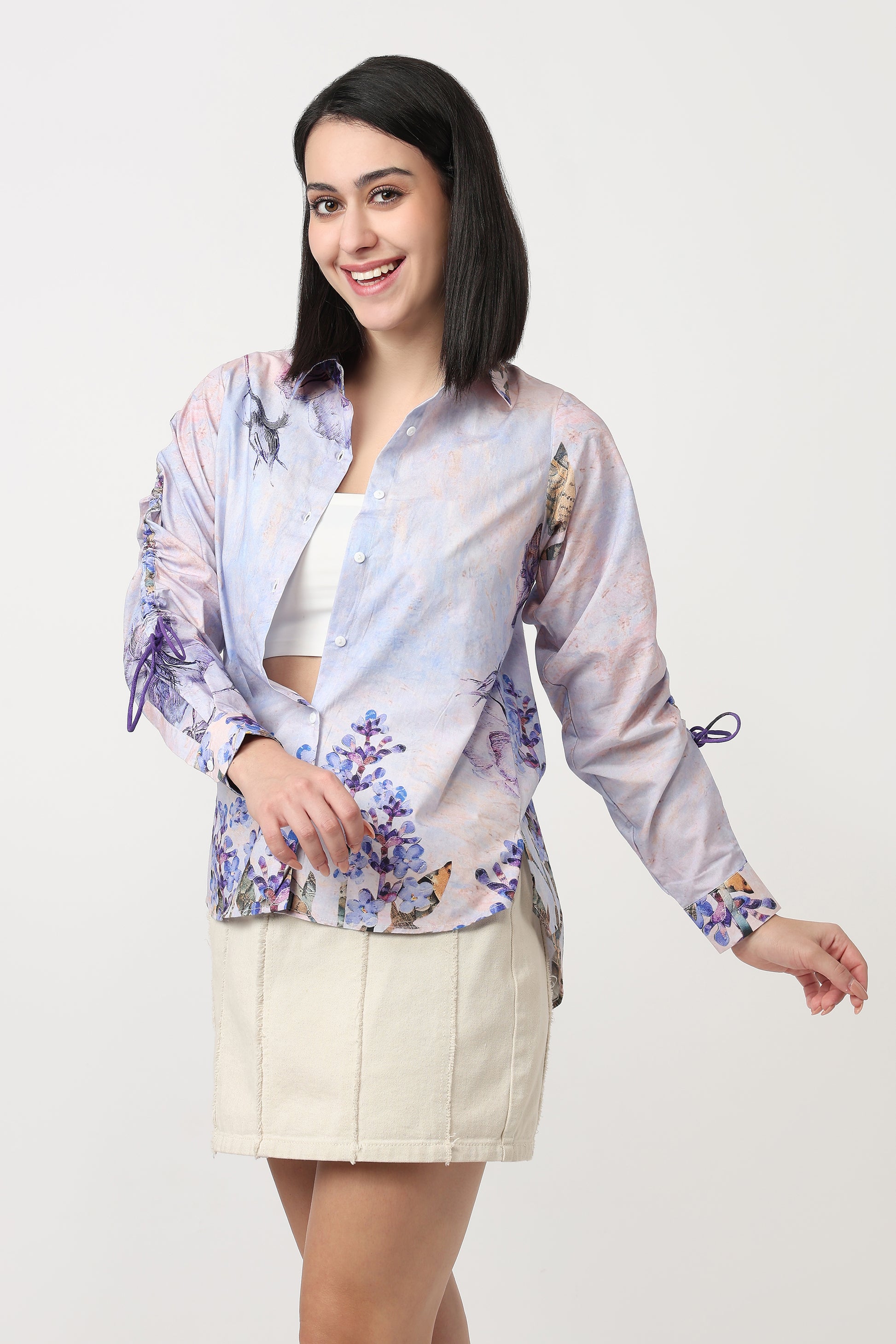 Woman wearing a floral blouse and beige skirt on a white background