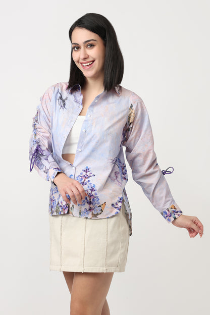 Woman wearing a floral blouse and beige skirt on a white background