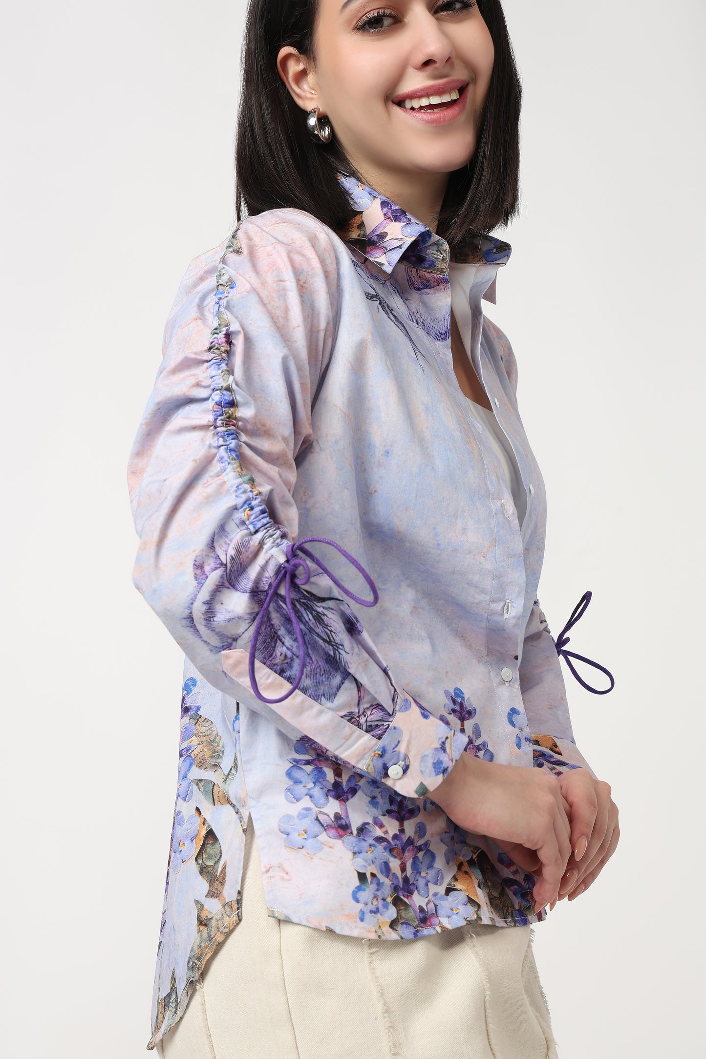 Woman wearing a floral blouse with long sleeves on a white background