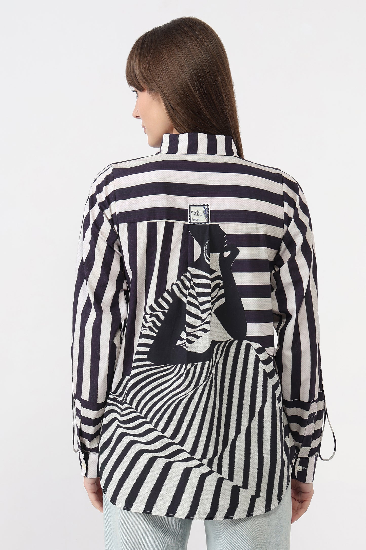 Woman wearing a black and white striped shirt with a zebra design on a white background