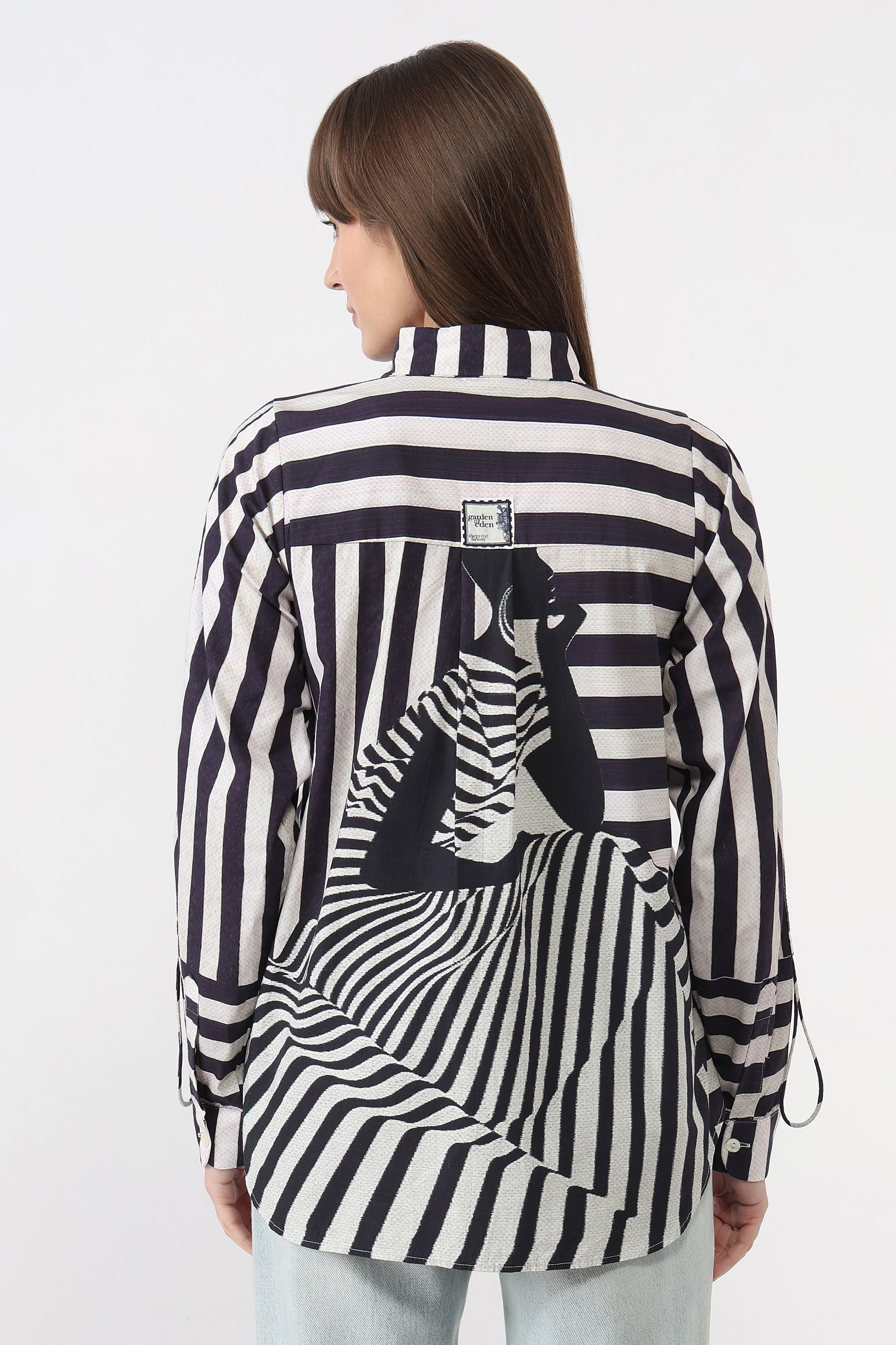 Woman wearing a black and white striped shirt with a zebra design on a white background
