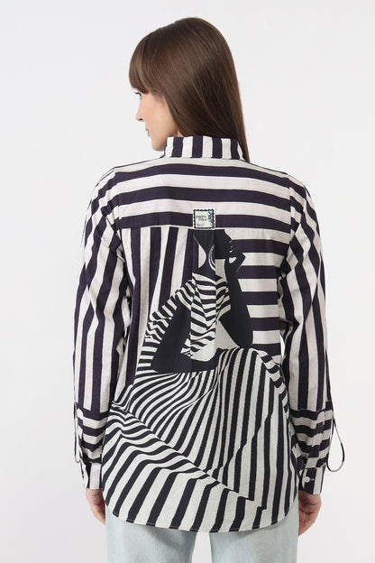 Woman wearing a black and white striped shirt with a zebra design on a white background