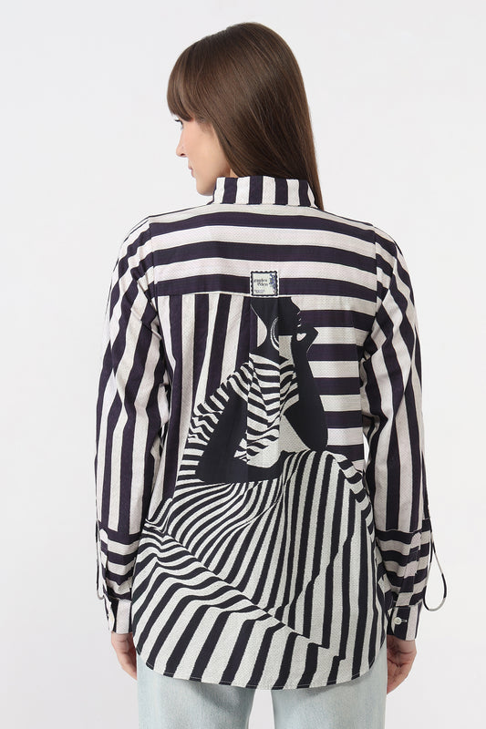Woman wearing a black and white striped shirt with a zebra design on a white background