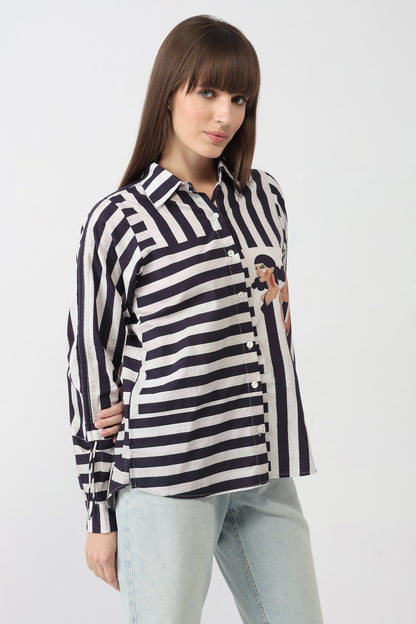 Woman wearing a black and white striped shirt with a graphic design on a white background